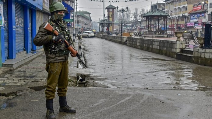 A security personnel stands guard at Lal chowk during a two day strike call