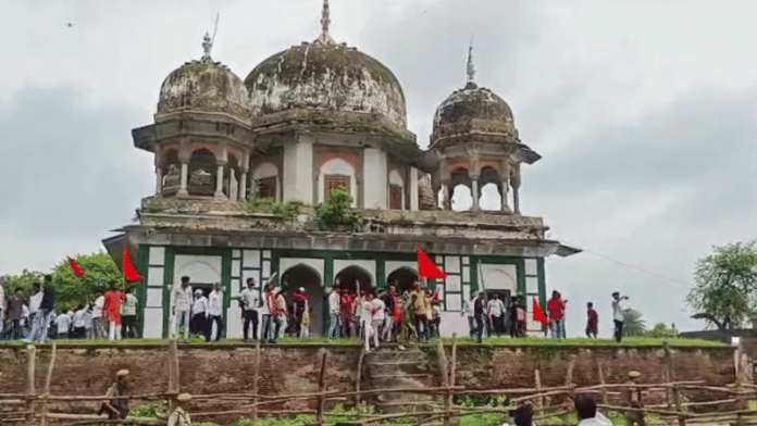 Members of Hindu organisations, including Bajrang Dal, gather near an old tomb, claiming it is a temple and demanding to offer prayers, at Abu Nagar in Fatehpur on Monday | ANI